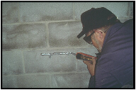Radon Techniques for New Home Construction: guy with a caulk gun
